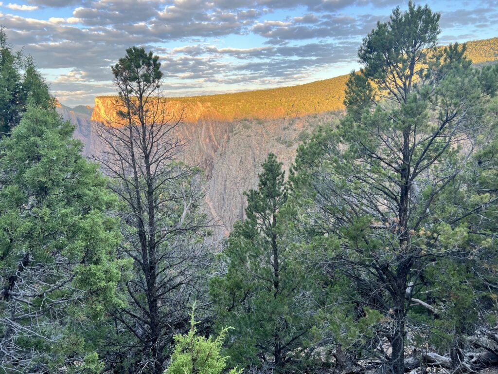 Hiker scrambling Class III boulders in Pinyon Draw, Black Canyon of the Gunnison North Rim.
